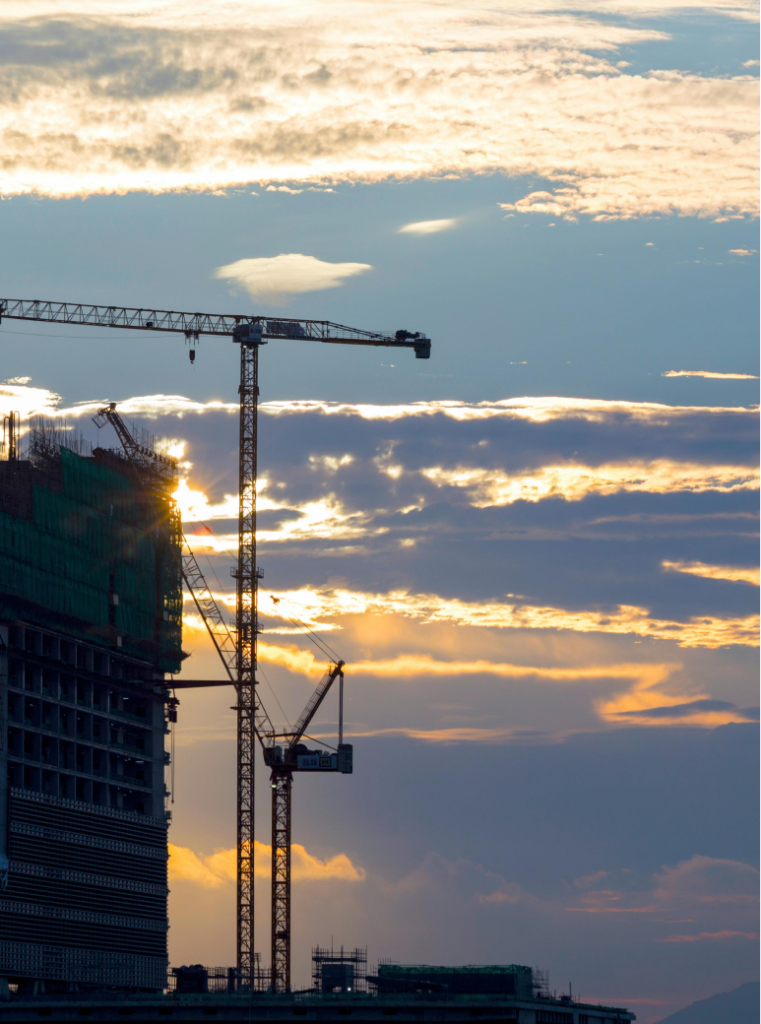 Crane in front of sky at sunset.